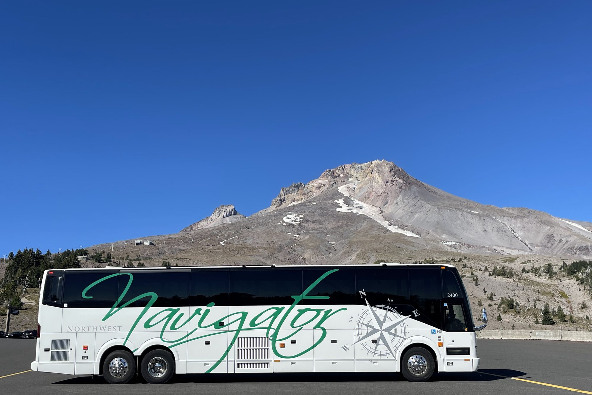 An NW Navigator coach parked below Mt. Hood