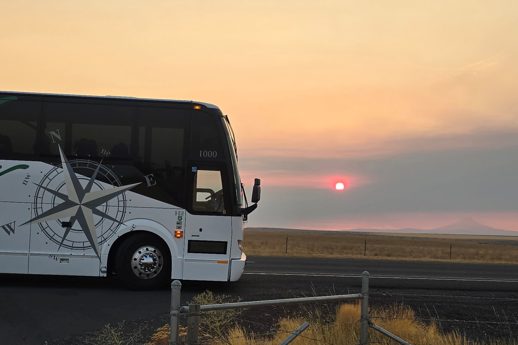 An NW Navigator coach on a roadside at sunset